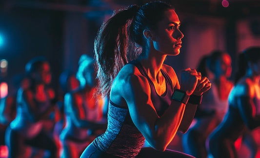 Group fitness class with attendee wearing a fitness tracker to monitor workout performance.